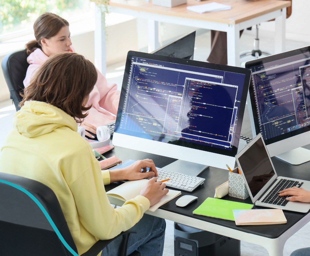 Teens coding together in the AverixAI program